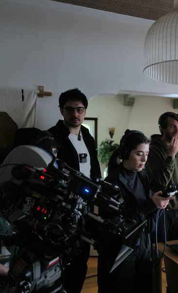 Pessoa ajustando uma câmera no set